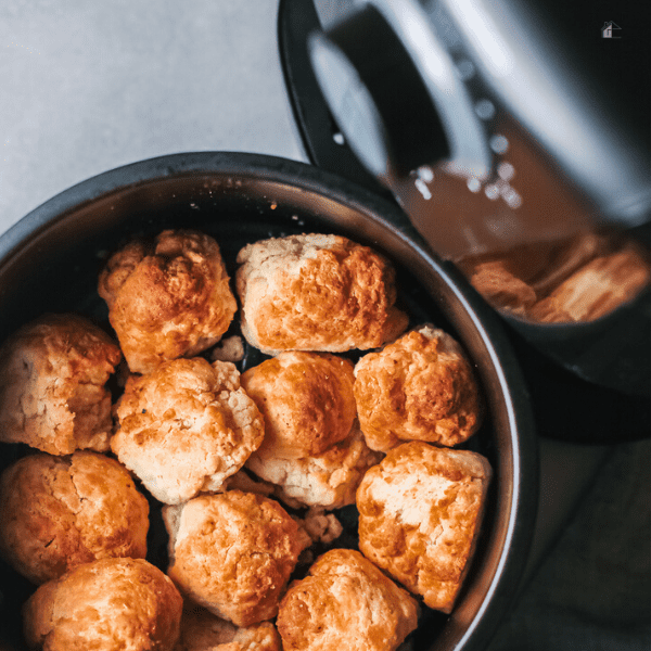 Baked donut holes inside air fryer basket.