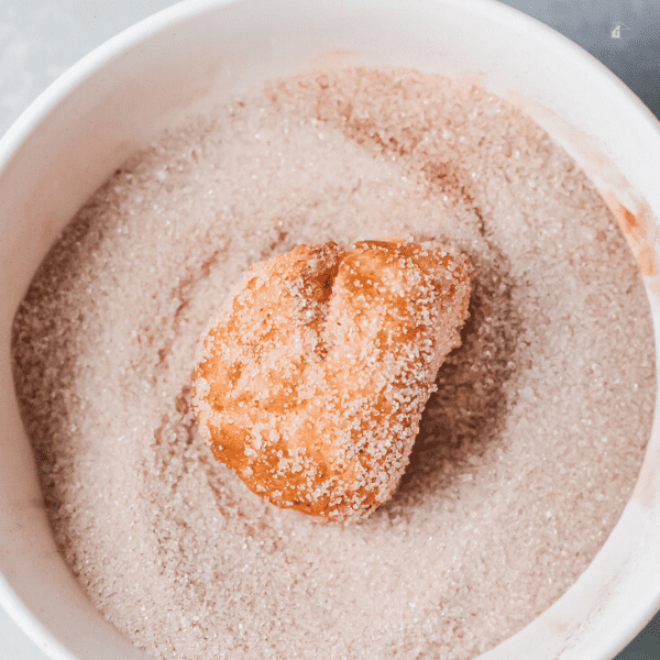 Donut hole coated with sugar.