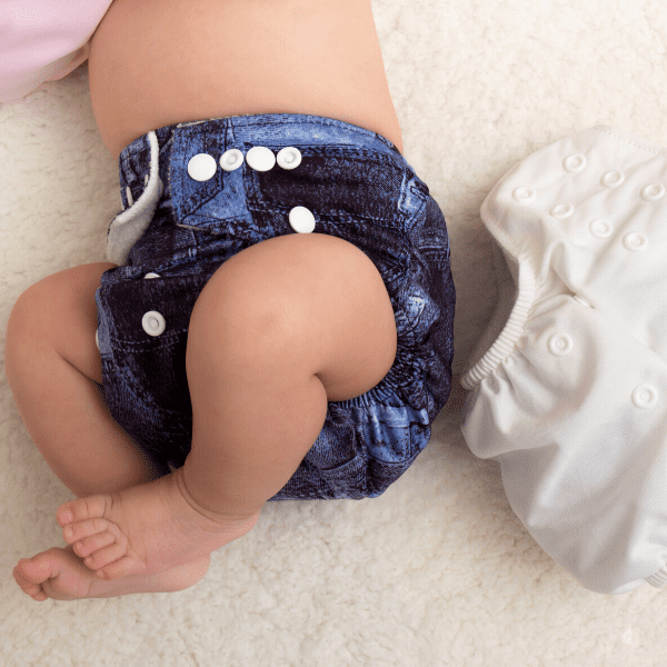 Baby lying down wearing cloth diaper