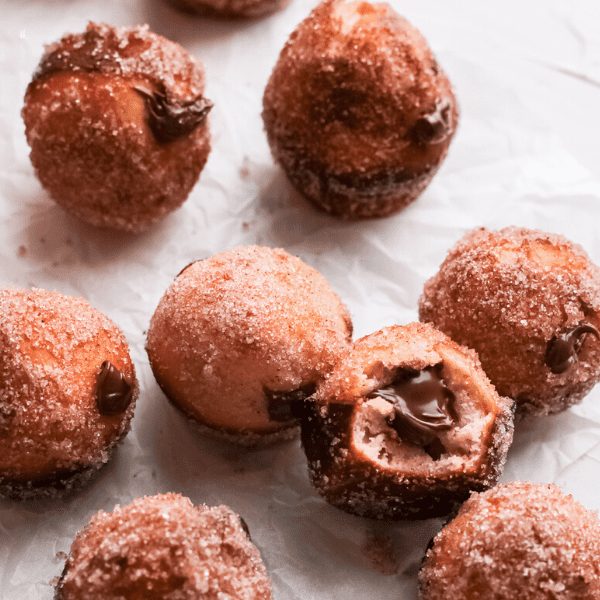 Baked Nutella Donut Holes with one bitten to show nutella inside
