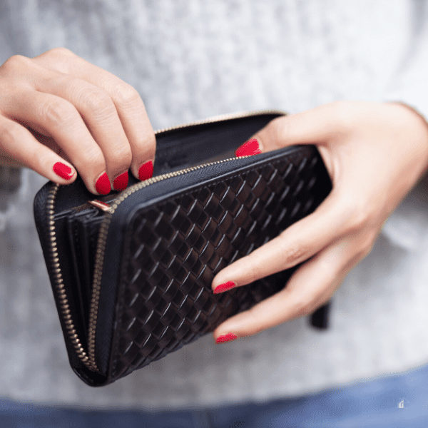 woman holding empty wallet.