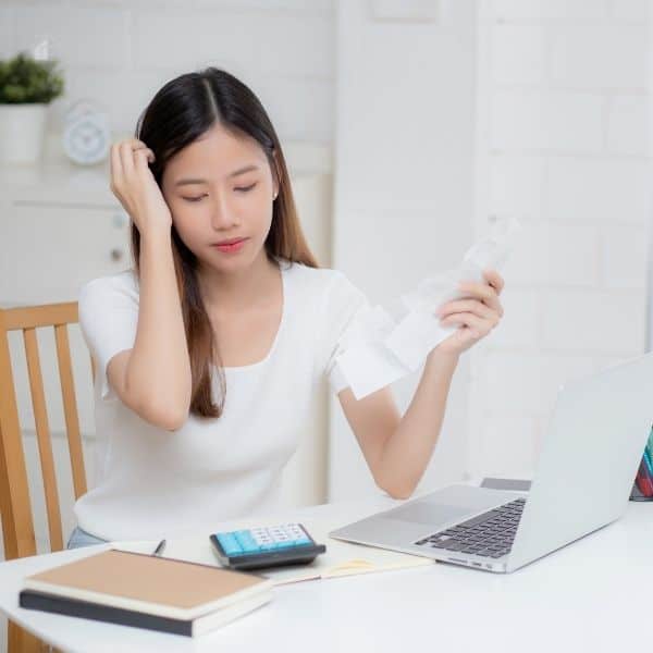Stressed Woman Calculating Budget at Home