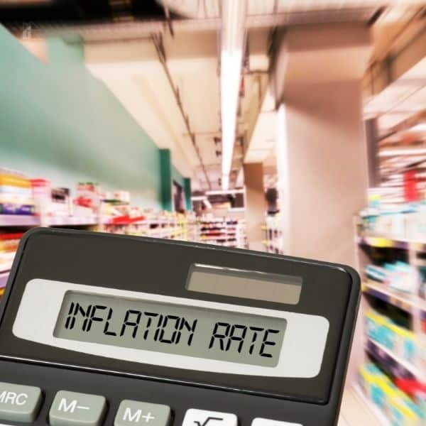 Supermarket with a closeup on a calculator with a text display Inflation Rate