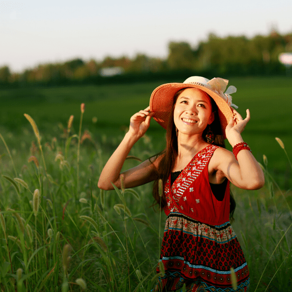 Woman in a field smiling.