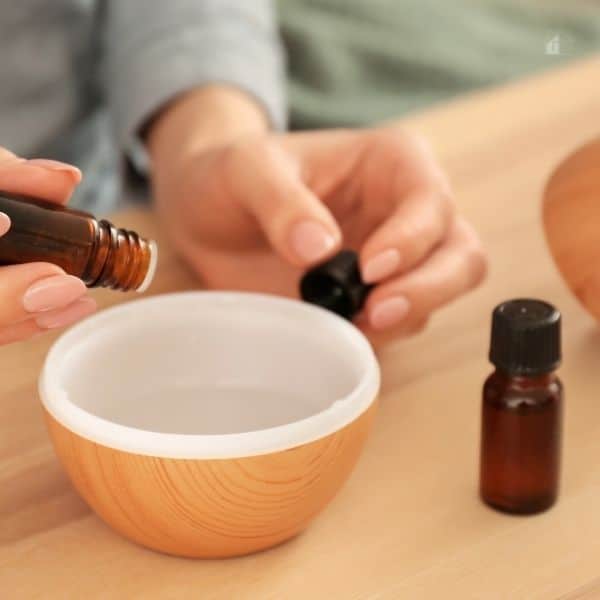 Woman Filling Essential Oil Diffuser, Closeup