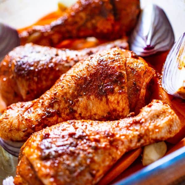 Raw marinated chicken legs ready to roast