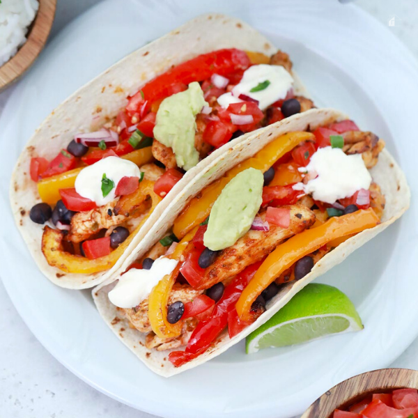 Air Fryer Chicken Fajita plated with a wedge of lime.