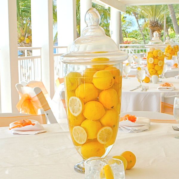 Lemons inside a large vase fille with water used as a table center piece 
