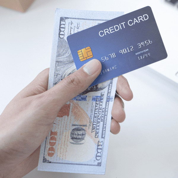 Young man holding a credit card and cash.