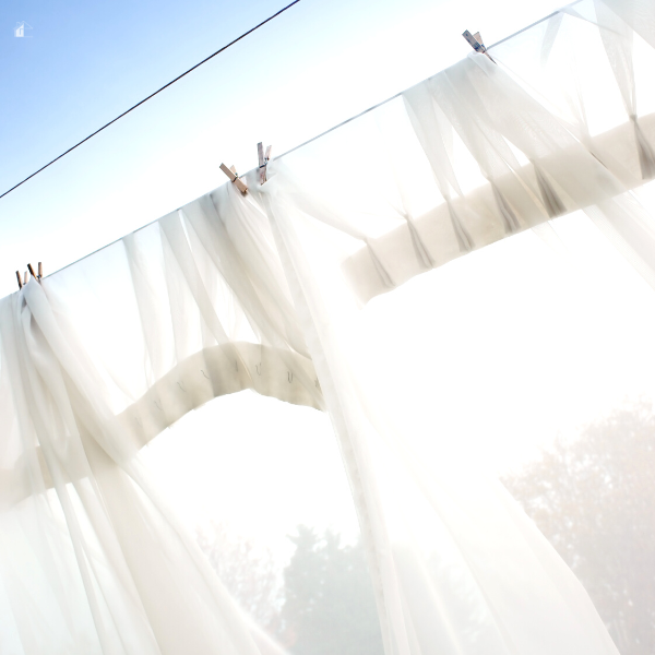 Washing line with net curtains drying.