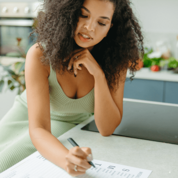 A woman making a weekly meal plan.