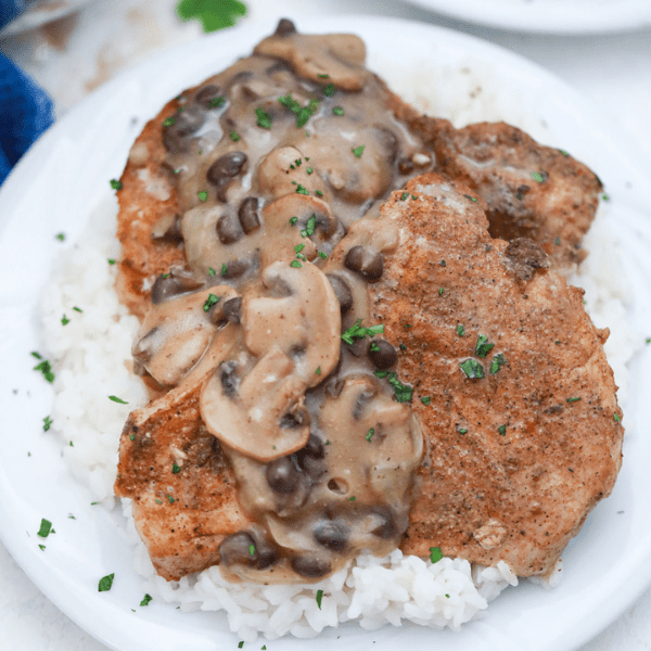 Pork chops covered with mushroom bean gravy over rice