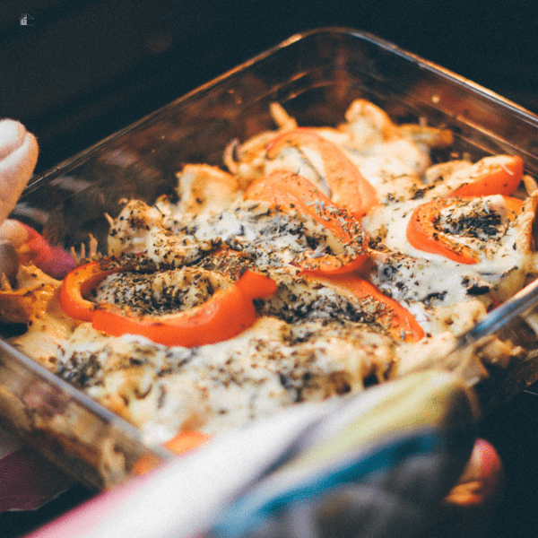 Person Holding Cooked Food on Clear Glass Container