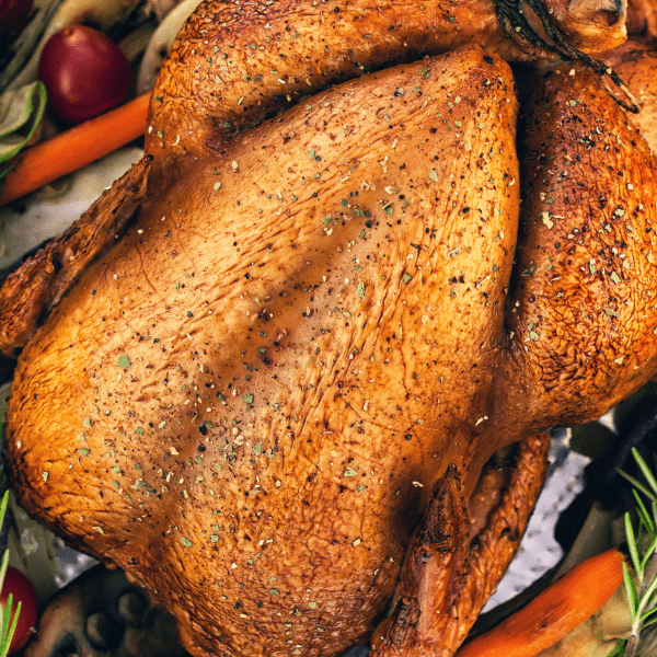 Close up of a cooked turkey with spices on top.