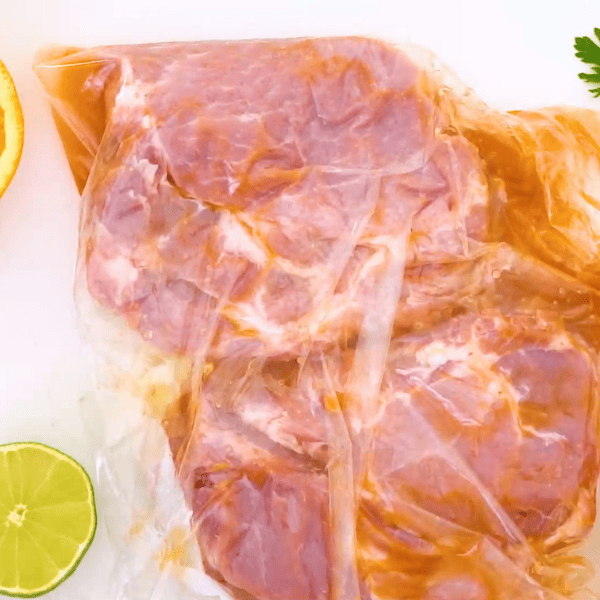 Marinaded pork steak in plastic freezer bag.