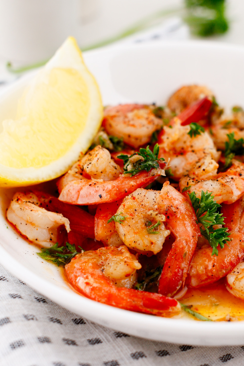 Puerto Rican shrimp recipe (camarones al ajillo) served in a bowl with lemon wedge, sautéed shrimp in garlic butter white wine sauce, fresh parsley, and paprika, easy Latin seafood dinner perfect with white rice or tostones.