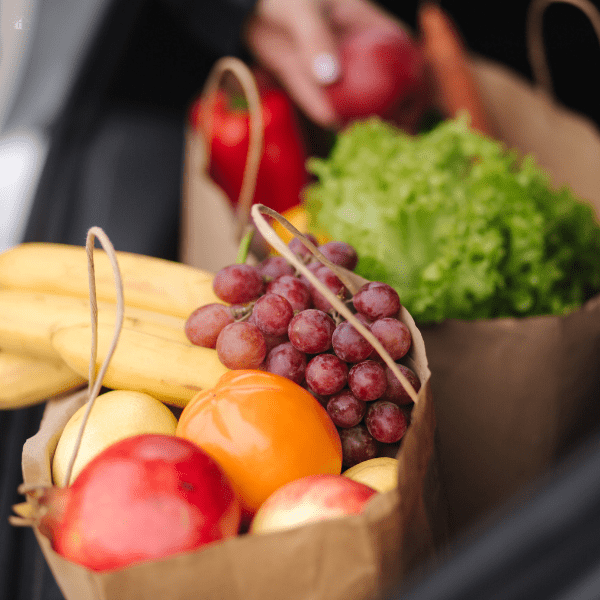 Close up of grocery paper bags in car trunk.