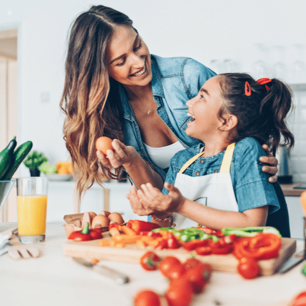 Mother and daughter cooking in the kitchen.