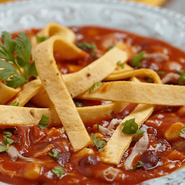 Chicken tortilla soup with bean, corn and tomato.