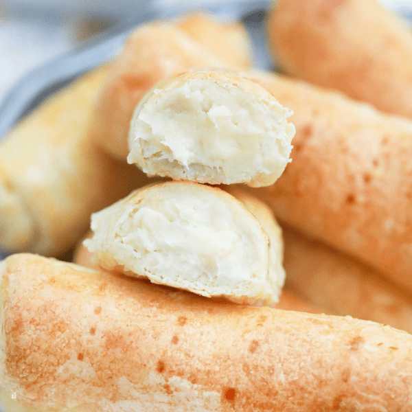 Close up of quesito showing inside filled with cheese.