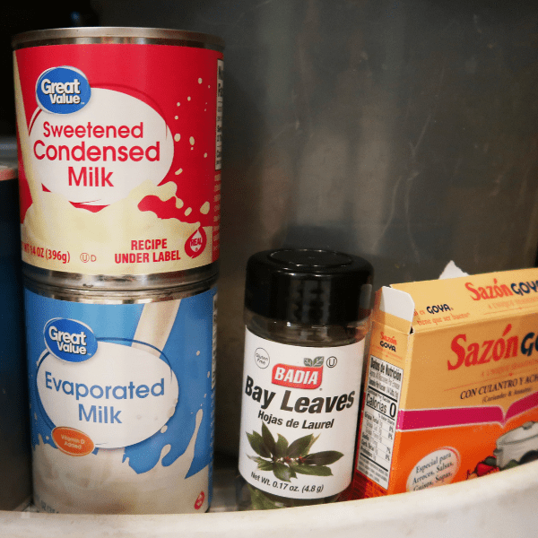condensed milk, evaporated milk, bay leaf in the pantry.