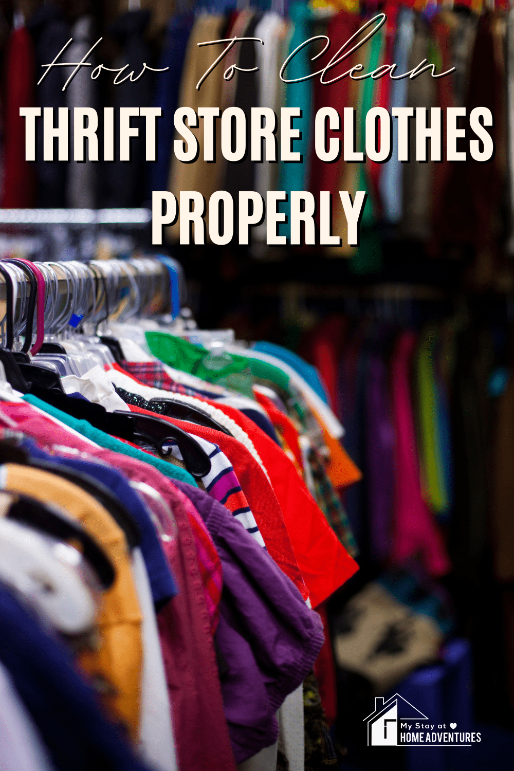 Thrift clothes hanging in a metallic bar with text