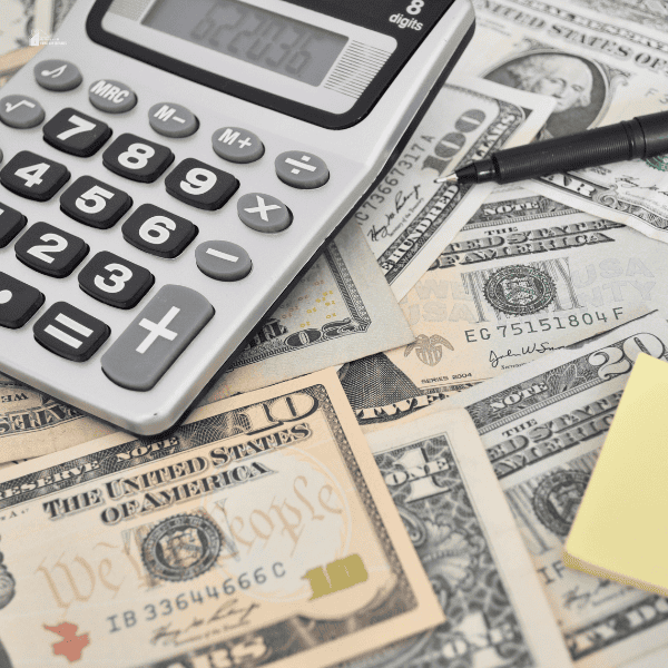 image of few cash with calculator on a table