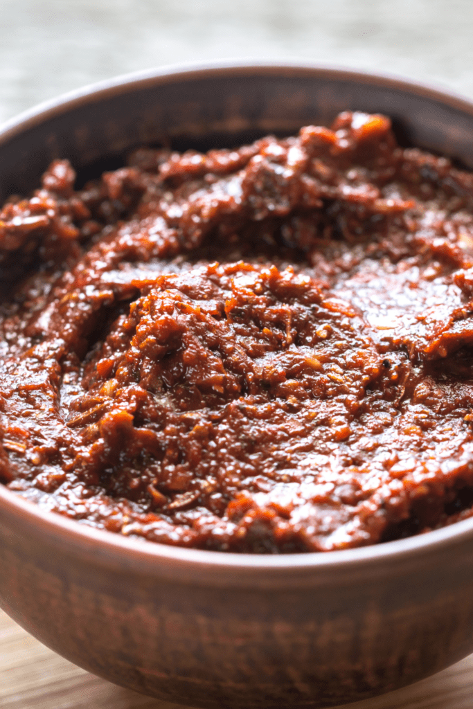 Closeup of Mexican adobo paste in a brown bowl.