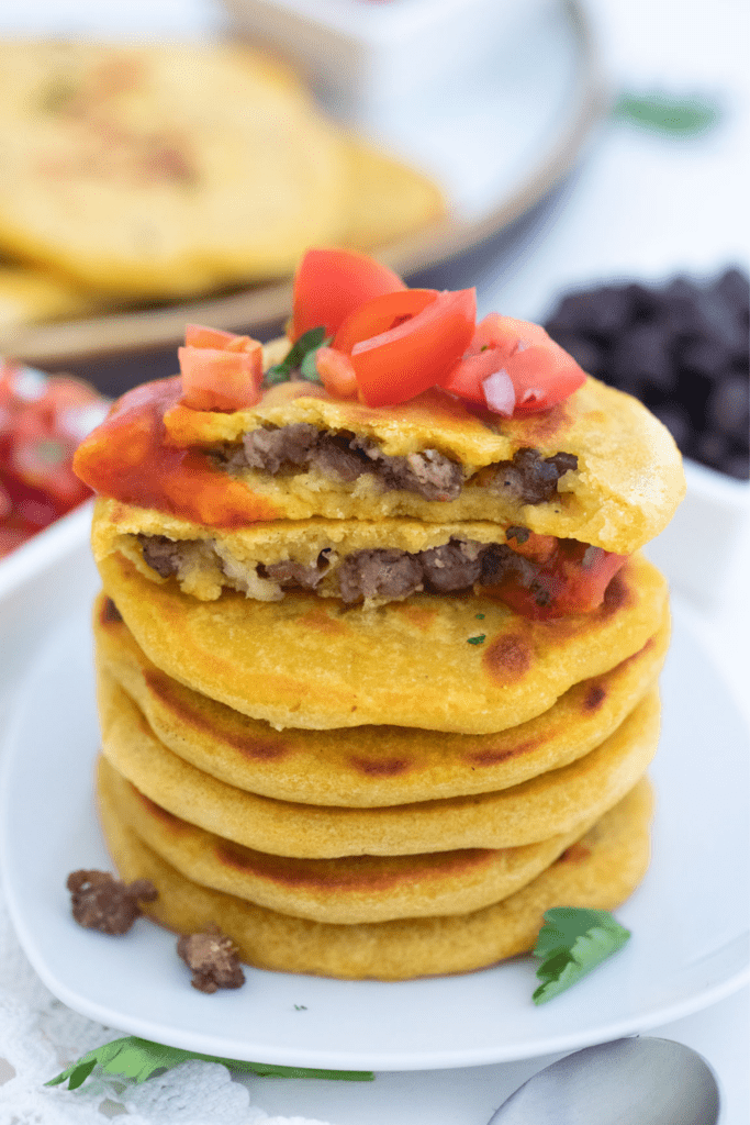 Ground beef pupusas plated and ready to eat.