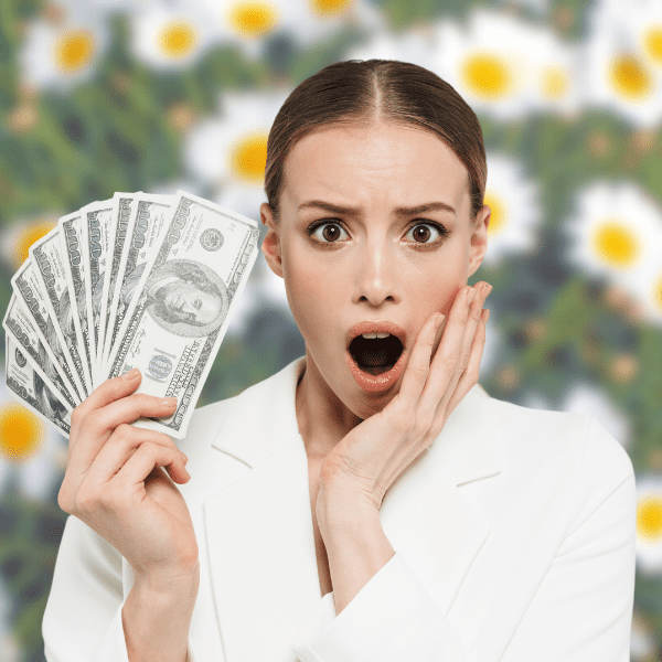 Woman holding cash and looking surprise.