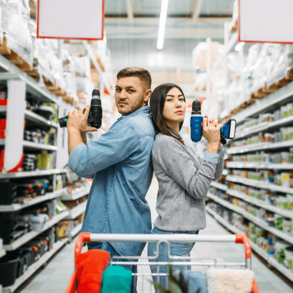 Couple with electric screwdrivers posing.