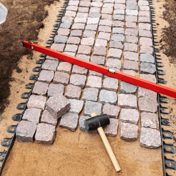 Granite cobblestone walkway under construction.