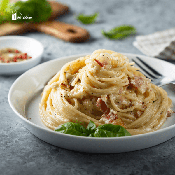 Homemade carbonara pasta on a white plate 