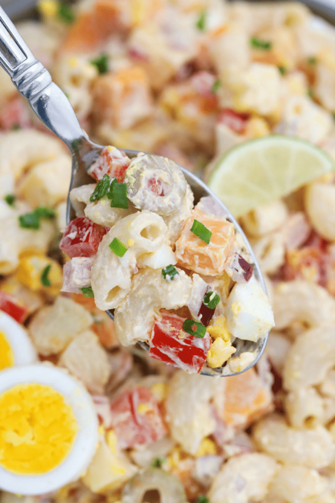 Close up of spoon full of Puerto Rican macaroni salad.