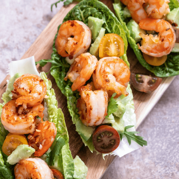 Lettuce wrapped shrimp tacos with fresh tomatoes, avocado and lime.
