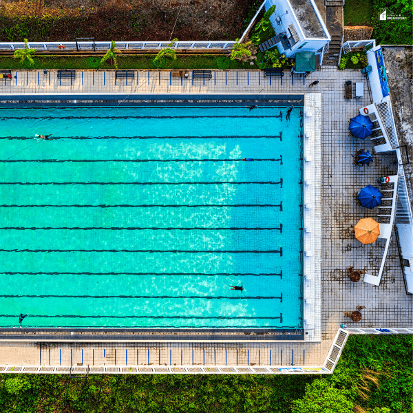 Overhead view of a swimming pool highlighting affordable summer activities that help save money.