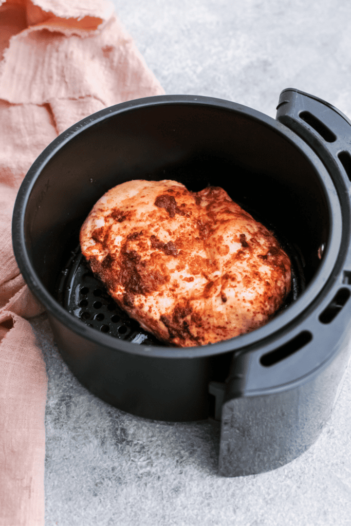 A photo of cooked chicken in an air fryer