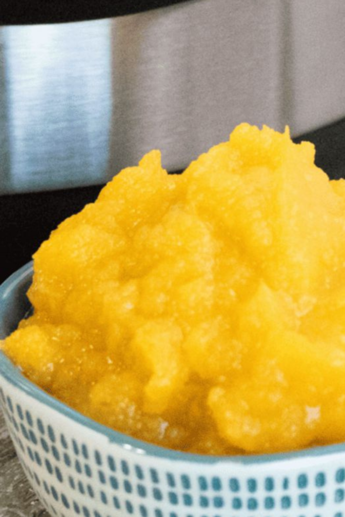A close-up of homemade pumpkin puree with an Instant Pot visible in the background.