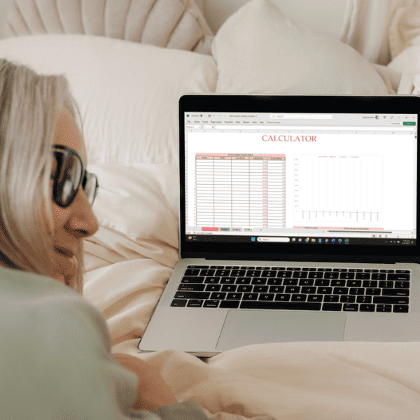 woman working on a laptop, screen showing spreadsheet.