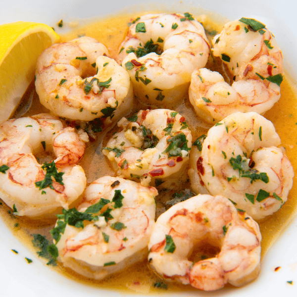 garlic lemon shrimp with red chili and parsley.