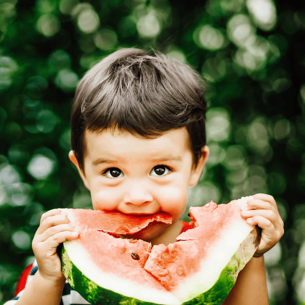 Little boy eating watermelon