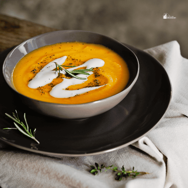 an image of pumpkin soup in a black bowl