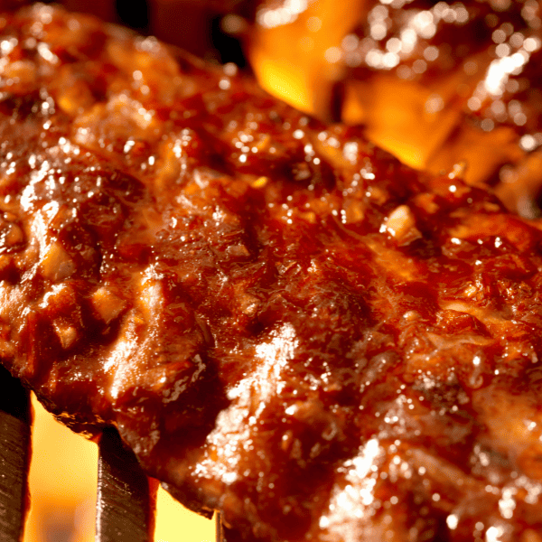 BBQ pork ribs cooking in a grill.