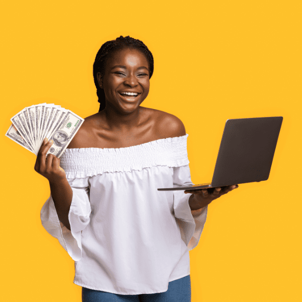 Woman holding cash and a laptop on the other hand.