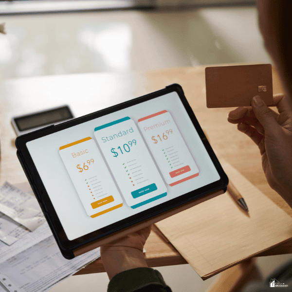 Person comparing mobile plans on a tablet with credit card in hand.