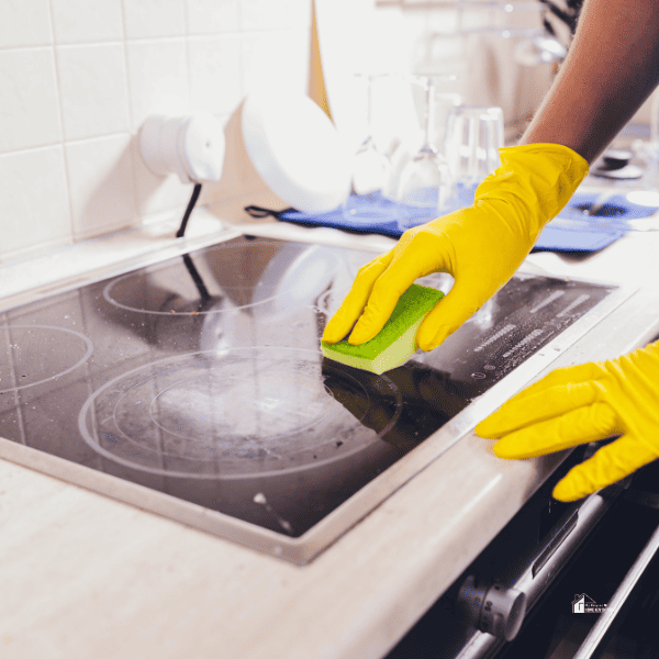 someone is cleaning the gas range