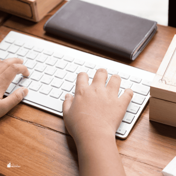 a kid typing on a keyboard