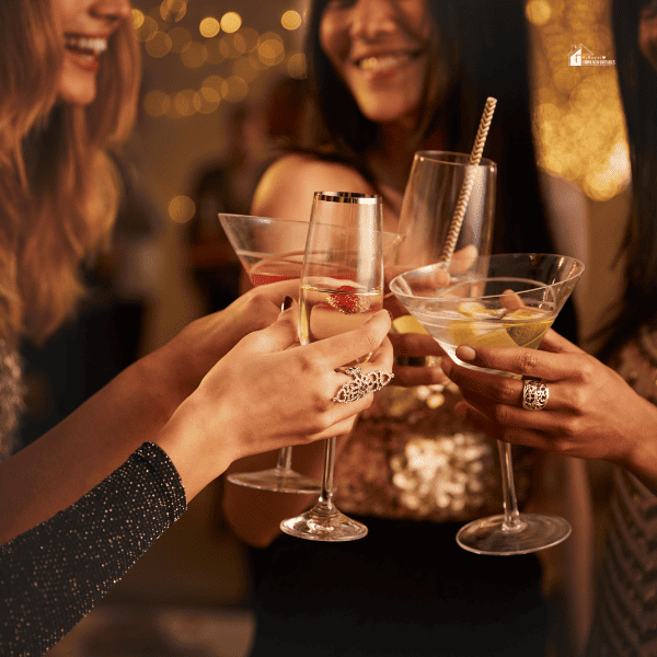 women partying while holding cocktail