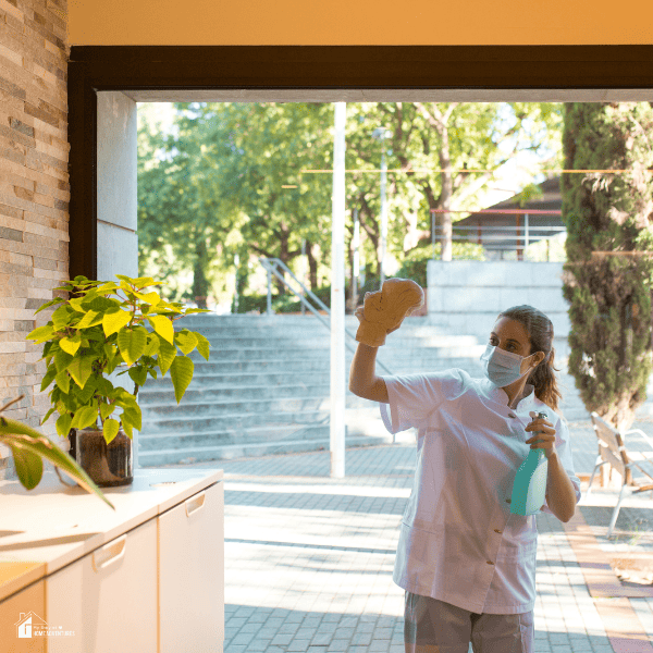 a lady cleaning the exterior glass