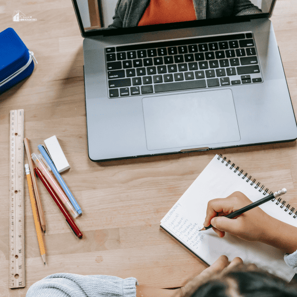 schoolgirl learning online with notebook